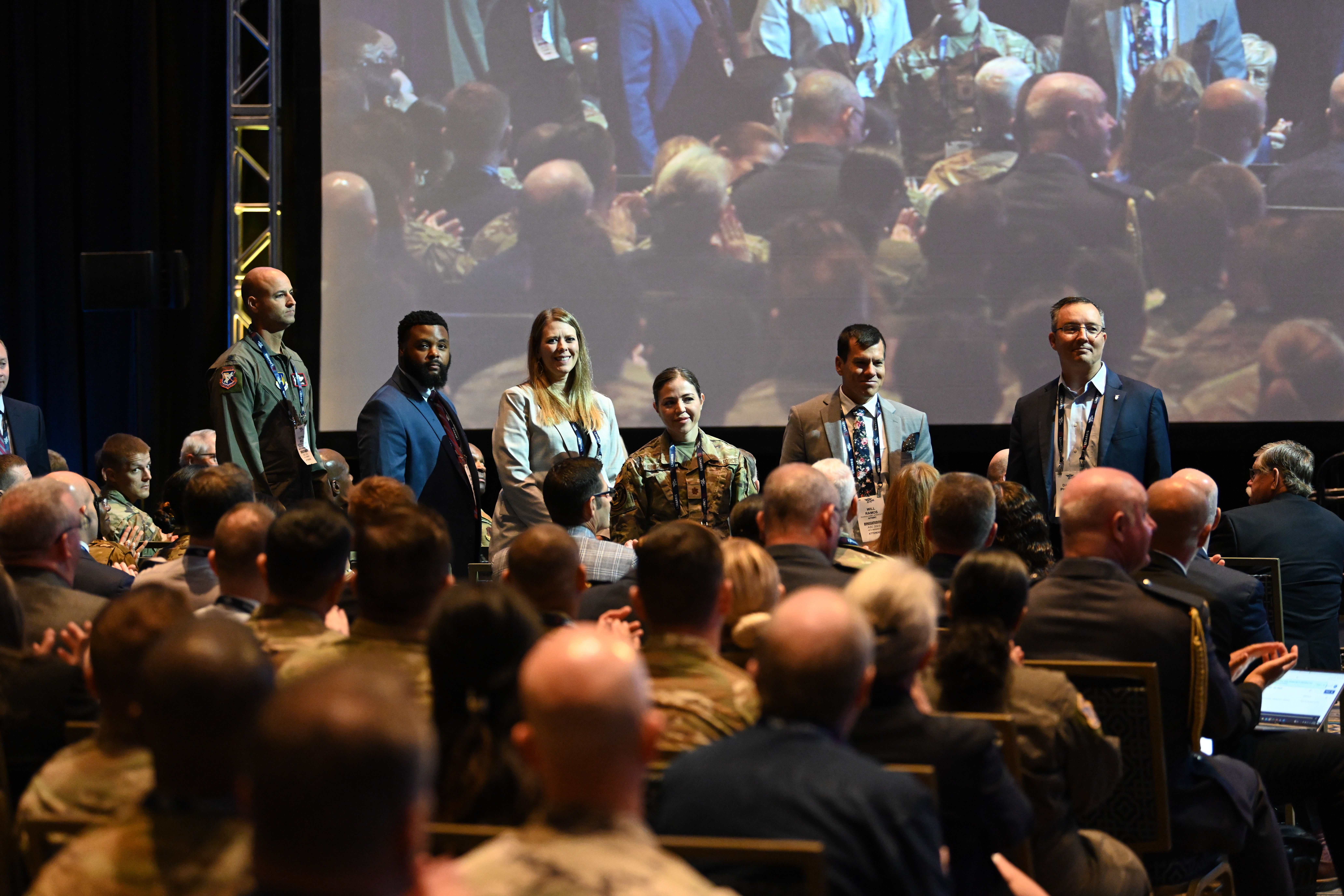 Key members of the B-21 Raider delivery team stand for recognition following Gen. Duke Z. Richardson, Commander, Air Force Materiel Command, keynote address titled, Blueprint to Bomber: AFMC's Crucial Role in the Delivery of the B-21, at the 2003 Air Space and Cyber Conference at the Gaylord National Resort and Convention Center in National Harbor, MD, Sept 11, 2023.